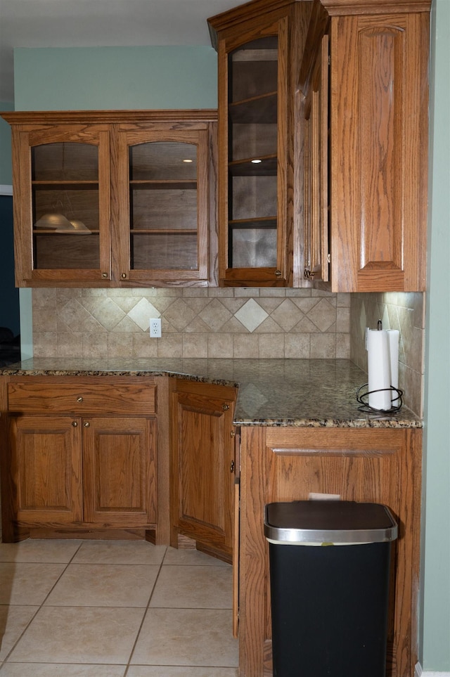 kitchen with backsplash, light stone counters, and light tile patterned floors