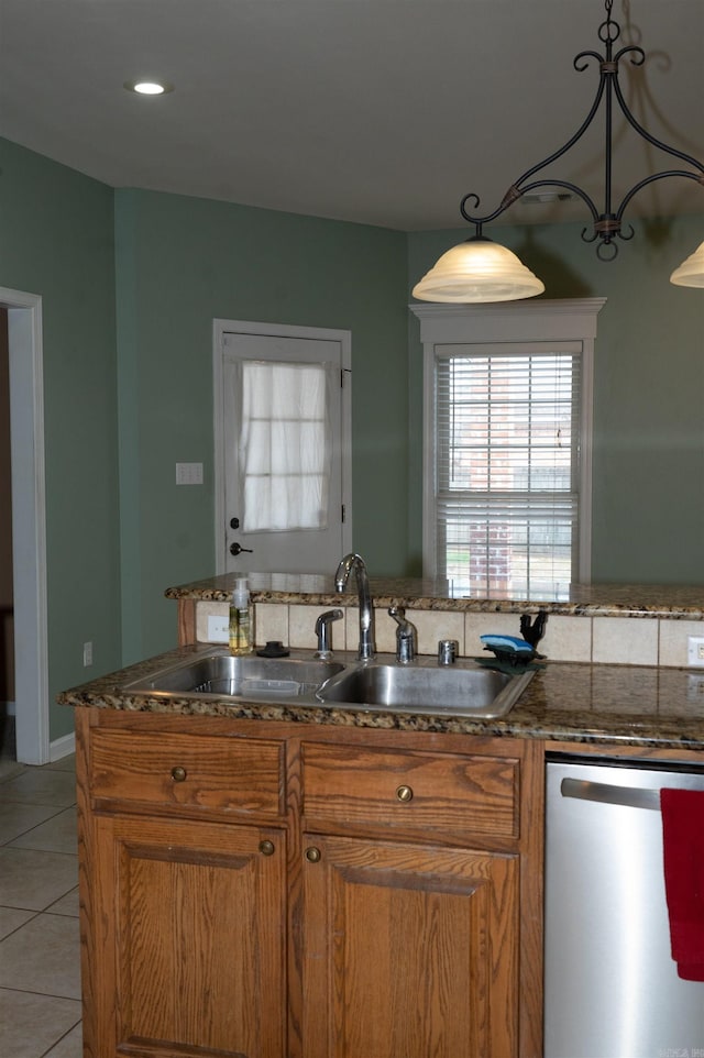 kitchen featuring light tile patterned flooring, dishwasher, pendant lighting, and sink