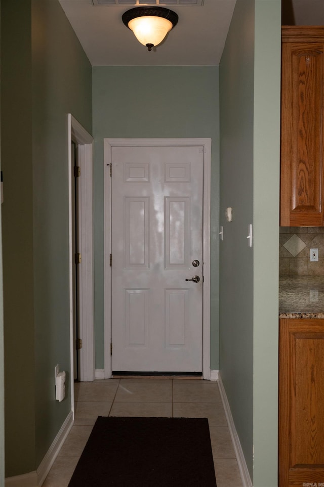 entryway with light tile patterned flooring