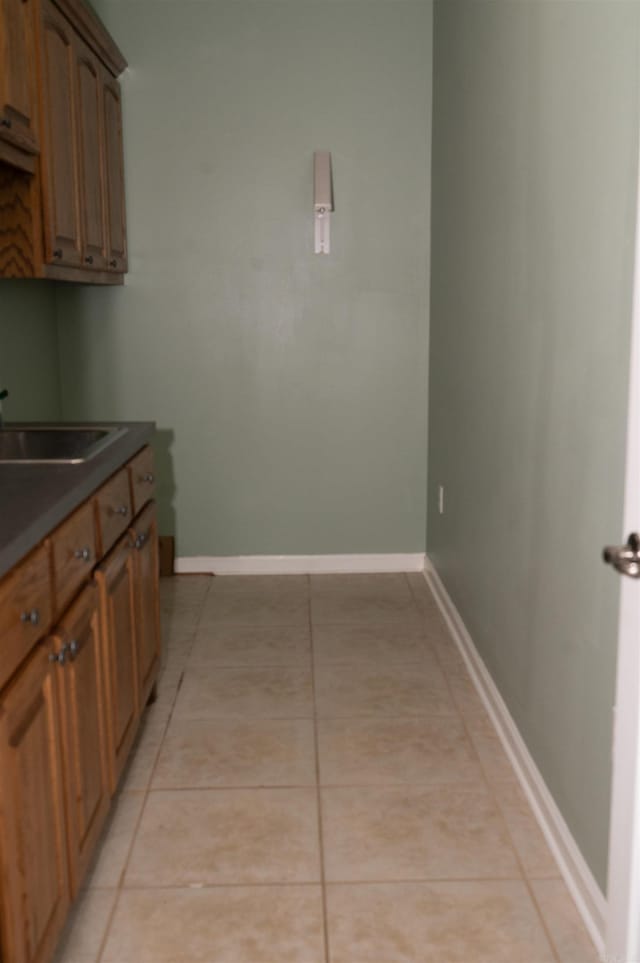 kitchen with sink and light tile patterned flooring