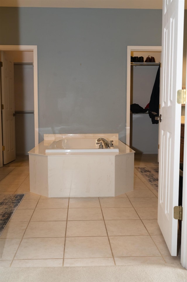 bathroom with tile patterned flooring and a bathing tub