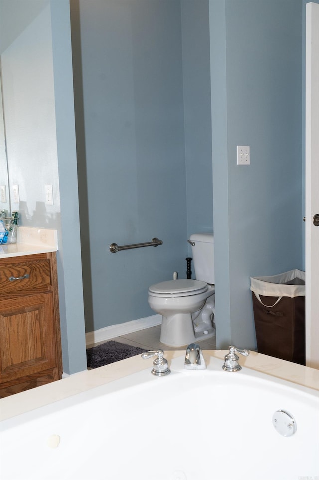 bathroom featuring toilet and vanity