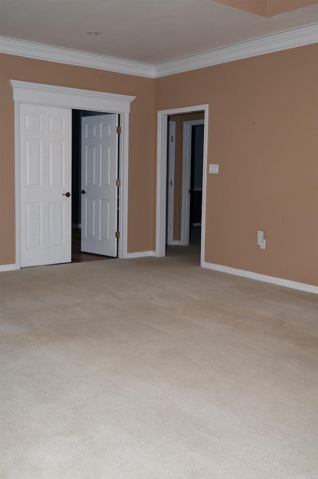 carpeted empty room with ornamental molding