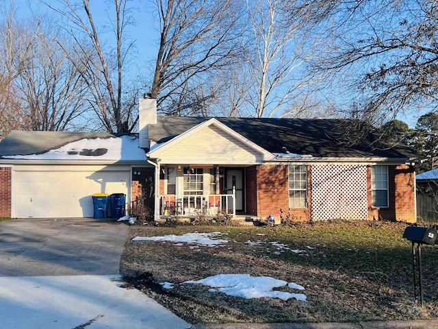 ranch-style home with a garage and covered porch