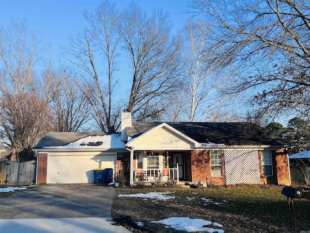 single story home featuring a garage and a porch