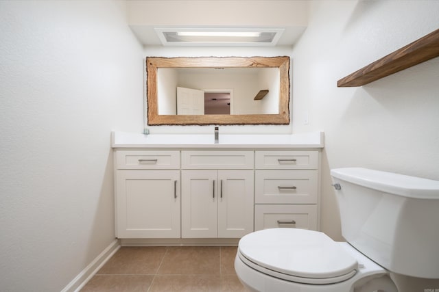 bathroom featuring toilet, tile patterned flooring, and vanity