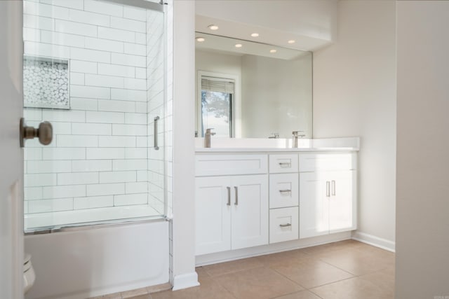 bathroom with bath / shower combo with glass door, tile patterned flooring, and vanity