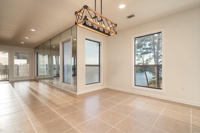 tiled spare room with plenty of natural light