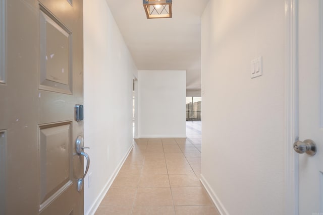 hall with light tile patterned floors