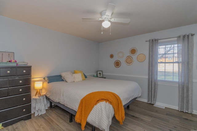 bedroom featuring ceiling fan and hardwood / wood-style flooring