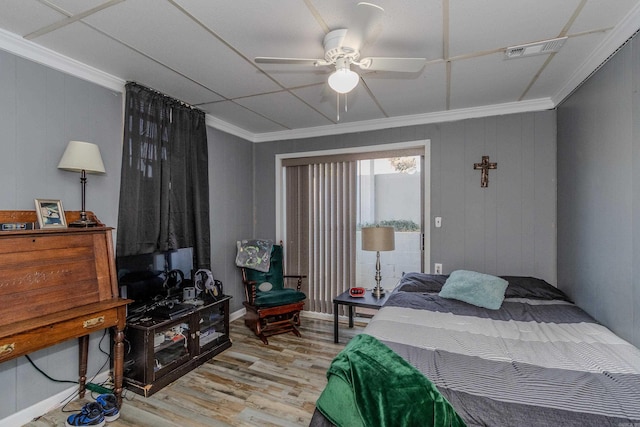 bedroom with ceiling fan, crown molding, and light wood-type flooring