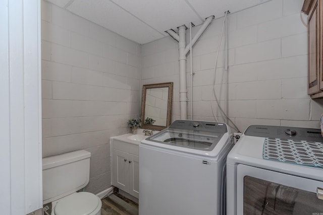 laundry room with washer and dryer and sink