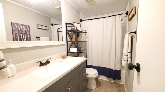 bathroom with curtained shower, a textured ceiling, toilet, wood-type flooring, and vanity