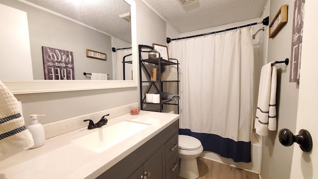 full bathroom featuring a textured ceiling, shower / tub combo, hardwood / wood-style floors, toilet, and vanity