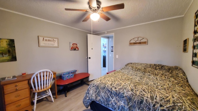 bedroom with ceiling fan, ornamental molding, a textured ceiling, and wood-type flooring