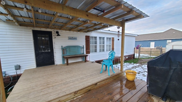 wooden terrace with a grill