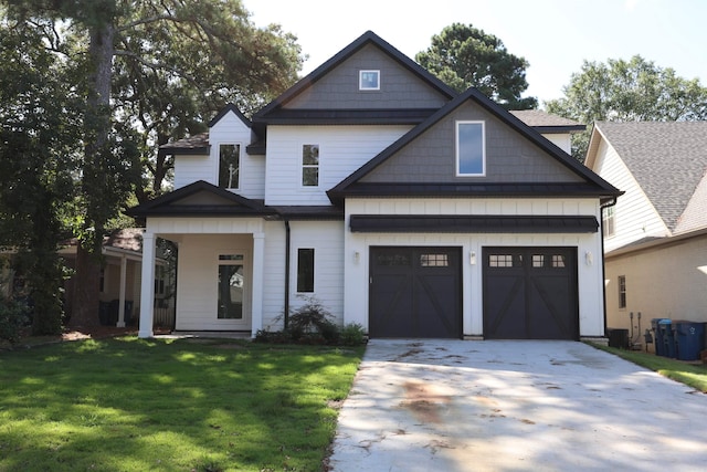 craftsman inspired home with a garage and a front lawn