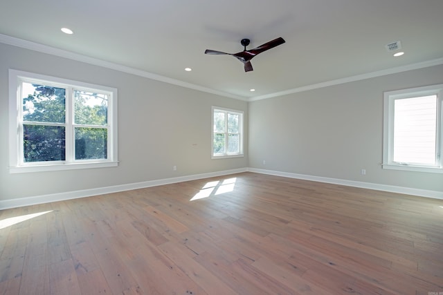 spare room with crown molding, ceiling fan, and light wood-type flooring