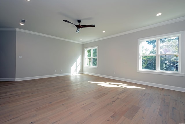 spare room with crown molding, ceiling fan, and a healthy amount of sunlight