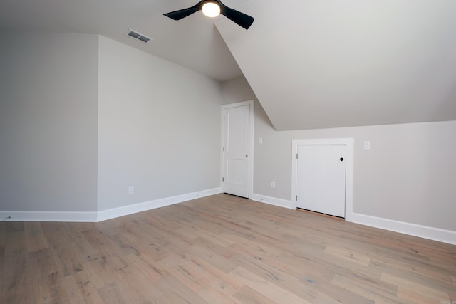 bonus room with ceiling fan, lofted ceiling, and light wood-type flooring