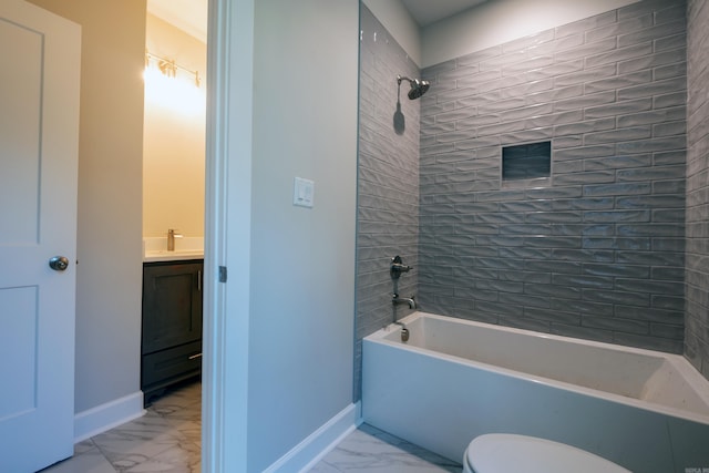 full bathroom featuring tiled shower / bath, vanity, and toilet