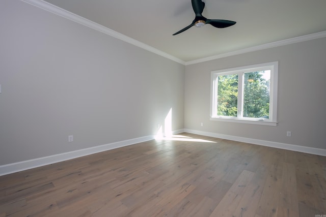 empty room featuring hardwood / wood-style floors, crown molding, and ceiling fan