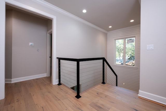 stairway with crown molding and hardwood / wood-style flooring