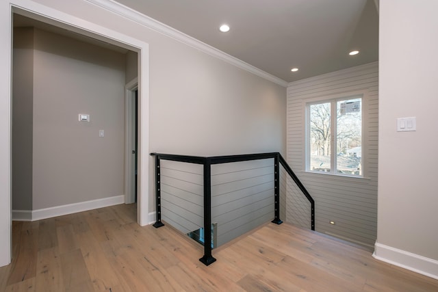 stairs featuring crown molding and hardwood / wood-style floors