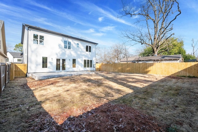 rear view of house with a yard