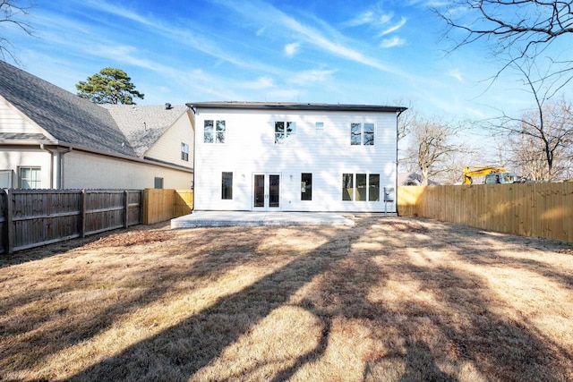 rear view of house featuring a yard and a patio