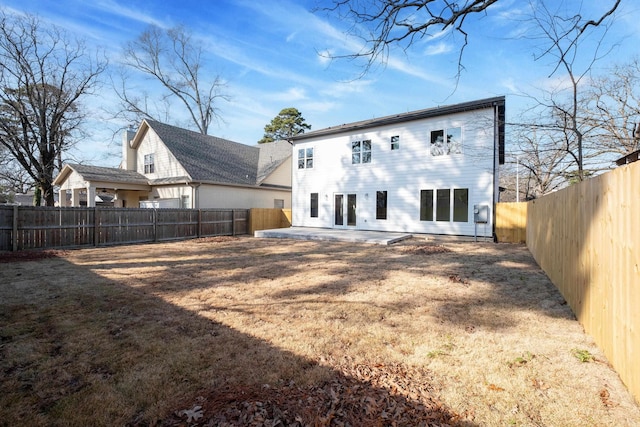 back of property with a patio and a yard