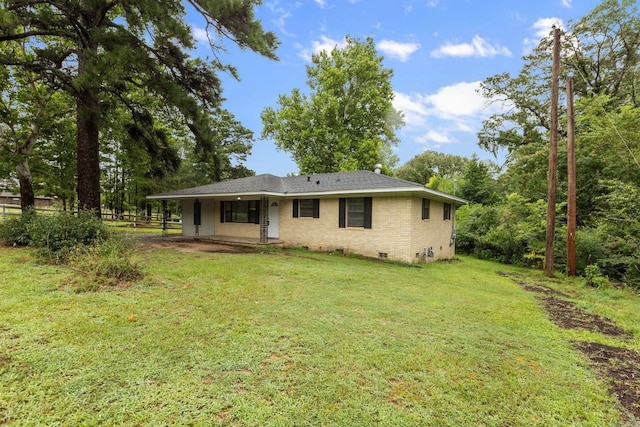 rear view of property with a lawn