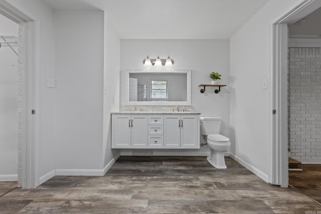 bathroom featuring hardwood / wood-style floors, vanity, and toilet