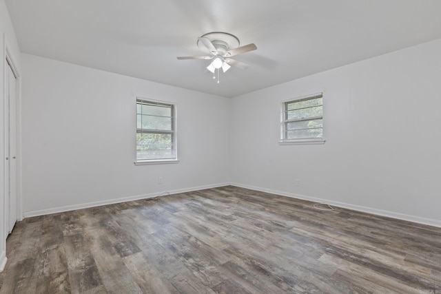 spare room featuring ceiling fan and dark hardwood / wood-style flooring