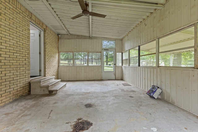 unfurnished sunroom with ceiling fan and vaulted ceiling