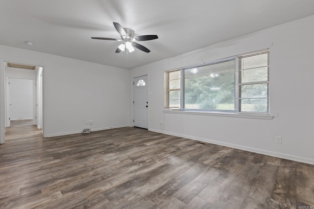 interior space with ceiling fan and dark wood-type flooring