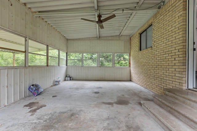 unfurnished sunroom featuring ceiling fan