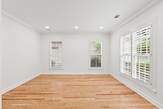 empty room with hardwood / wood-style flooring and ornamental molding