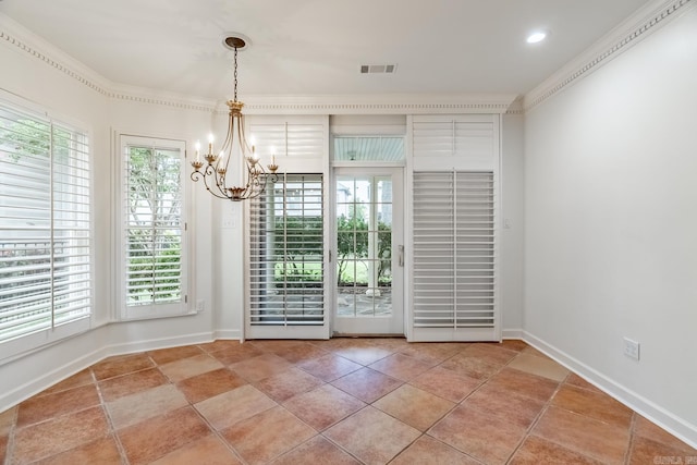 unfurnished dining area featuring a chandelier, crown molding, and plenty of natural light