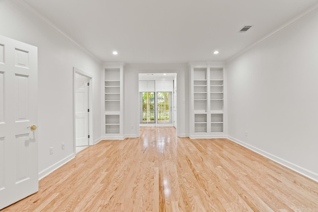 unfurnished living room with ornamental molding, light hardwood / wood-style flooring, and built in shelves