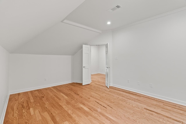 bonus room featuring lofted ceiling and light wood-type flooring