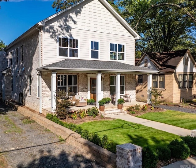 view of front of house featuring a porch and a front lawn