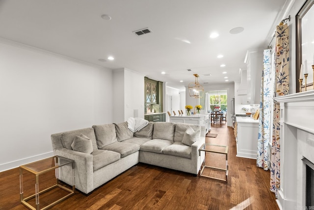 living room with ornamental molding and dark wood-type flooring