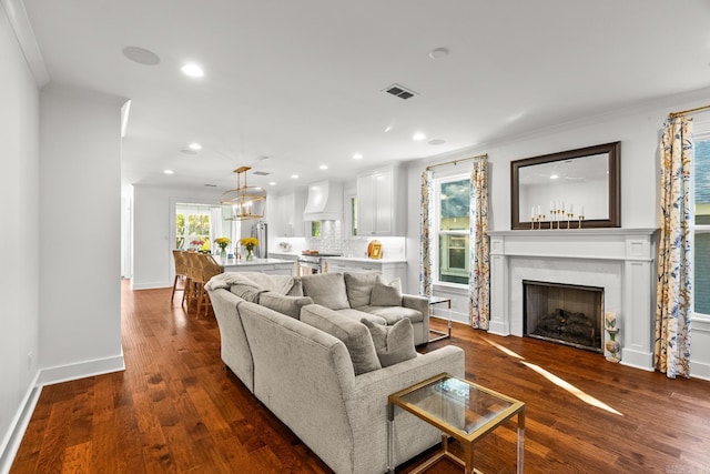 living room featuring ornamental molding and dark hardwood / wood-style floors