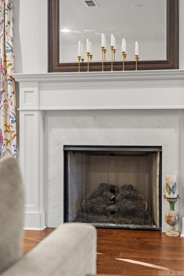 room details featuring a high end fireplace and wood-type flooring