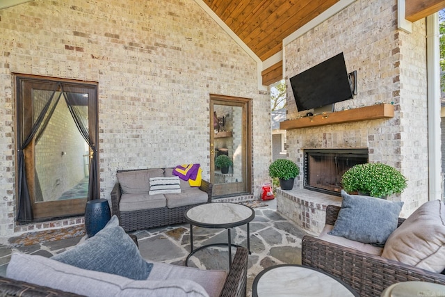 view of patio / terrace featuring an outdoor stone fireplace