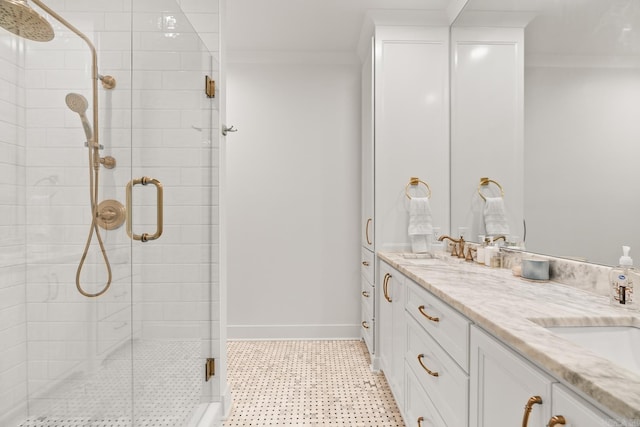 bathroom with ornamental molding, vanity, and a shower with shower door