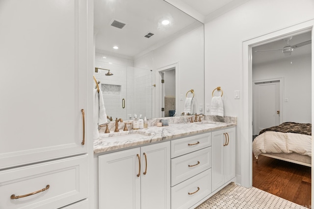 bathroom with ceiling fan, crown molding, vanity, and a shower with shower door