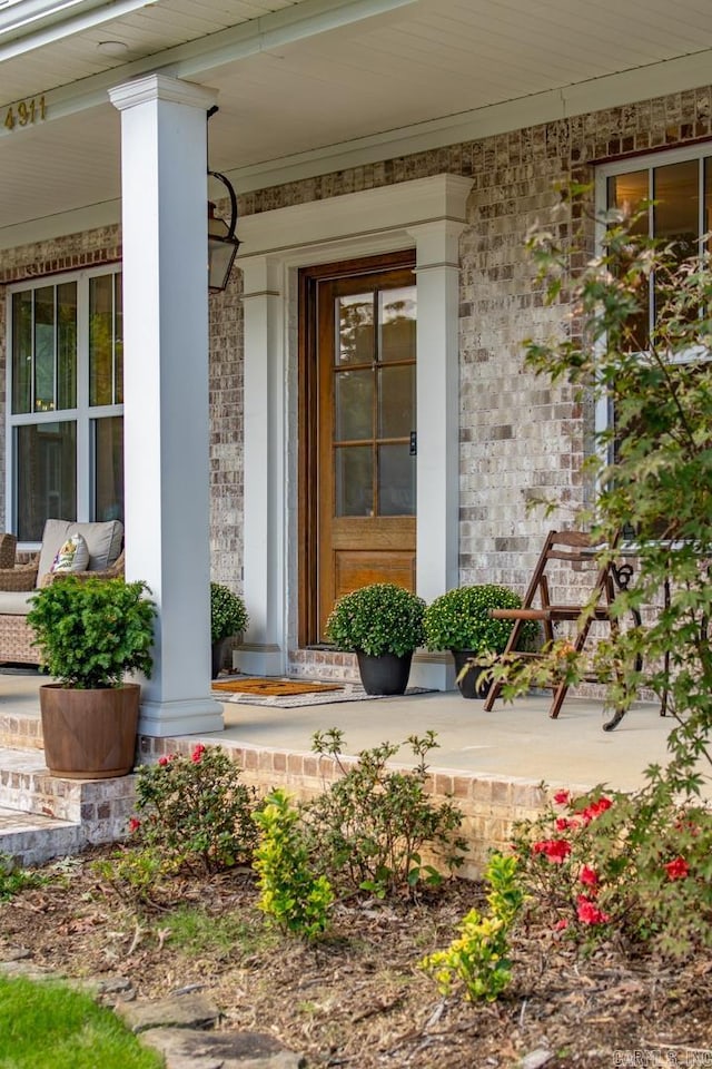 view of exterior entry featuring a porch