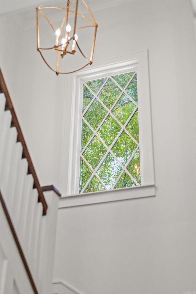 stairs with an inviting chandelier